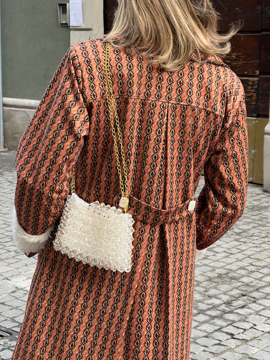 Alternate back view of handmade burnt-orange vintage-inspired coat with geometric pattern and buckle-belt detail