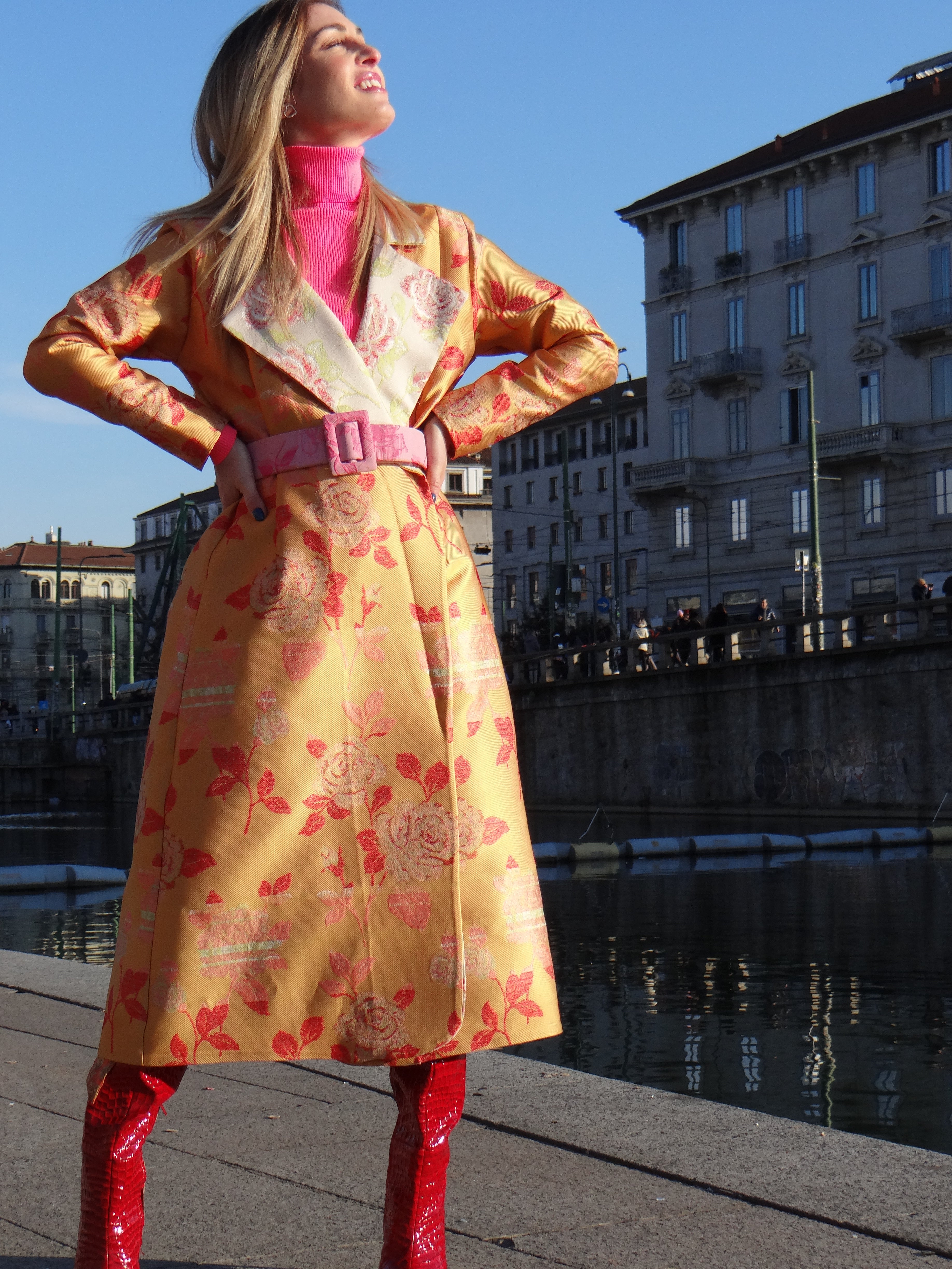 Front view of handmade orange jacquard coat with fringed back panel