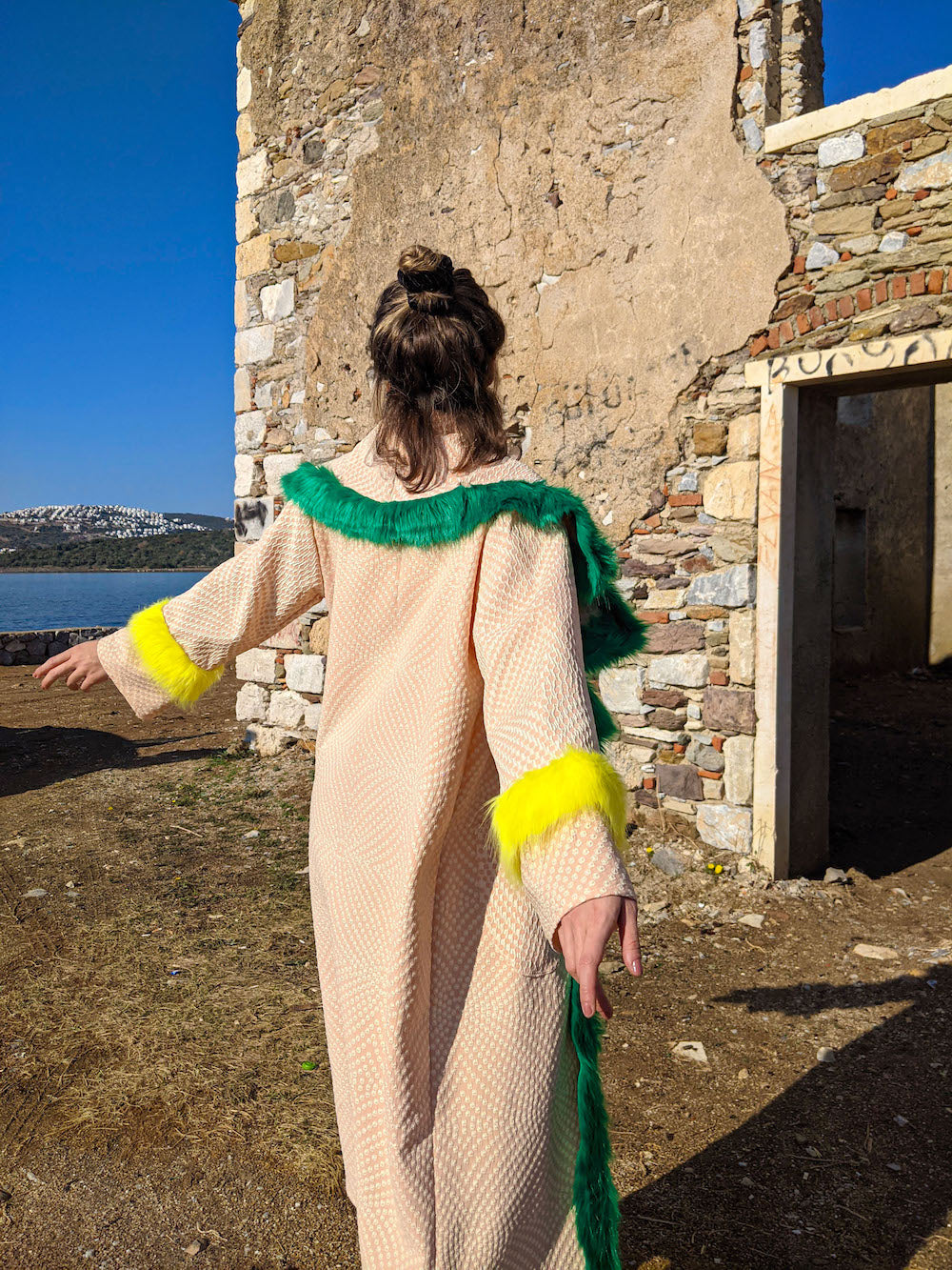 Back view of handmade pink kimono jacket showing draped silhouette and oversized collar.