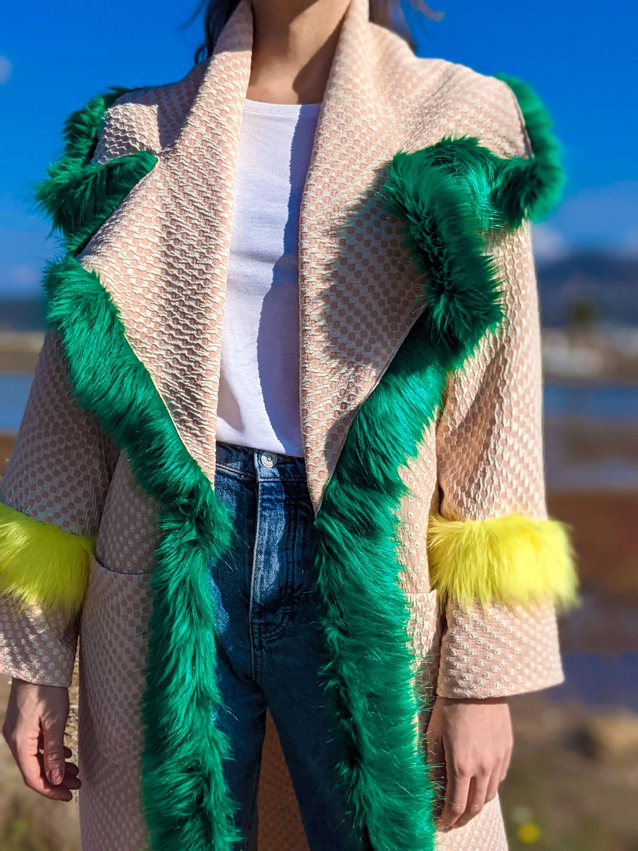 Close-up of oversized collar trimmed with green faux fur on handmade pink kimono jacket.